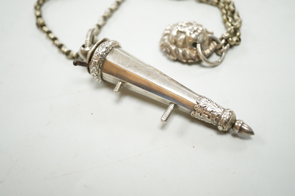 A Victorian silver whistle and case by George Unite, Birmingham, 1860, 93mm, suspended from a white metal chain with lion mask mount.
